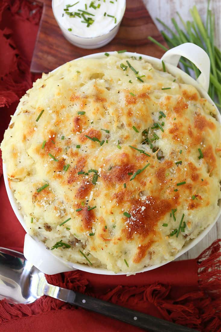 A potato side dish baked with cheese and topped with scallions