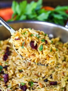 rice pilaf on serving spoon over skillet