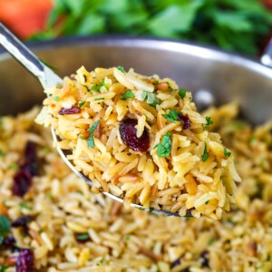 rice pilaf on serving spoon over skillet