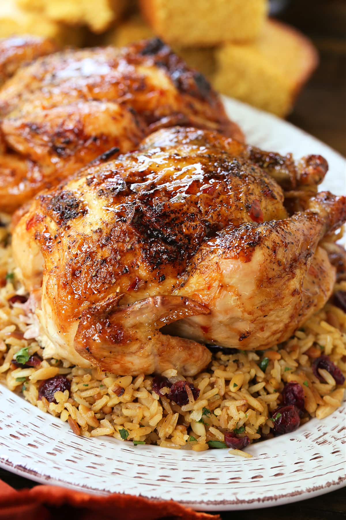 roasted cornish hen on bed of rice pilaf with cranberries