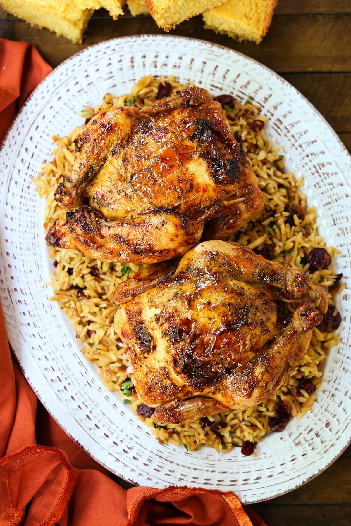 platter of cornish hens on a bed of rice