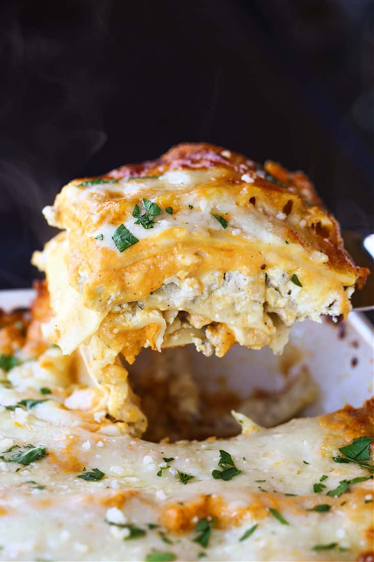 Slice of turkey lasagna being lifted out of a baking dish