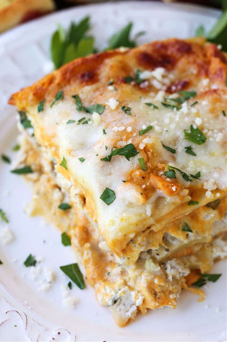 Slice of lasagna on a plate with parsley