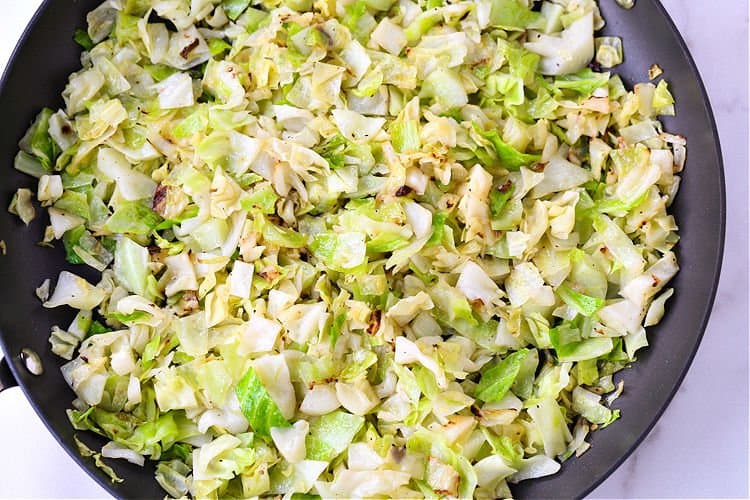 This Cabbage Roll Casserole is a comforting, easy to make dinner recipe! All your favorite cabbage roll ingredients in a delicious, easy casserole! cabbage cooking in a skillet