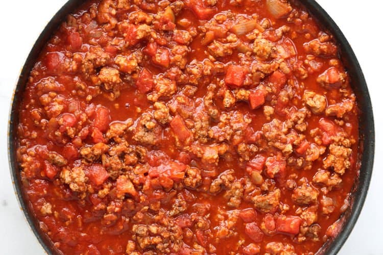 This Cabbage Roll Casserole is a comforting, easy to make dinner recipe! All your favorite cabbage roll ingredients in a delicious, easy casserole! Meat sauce in a skillet for casserole recipe
