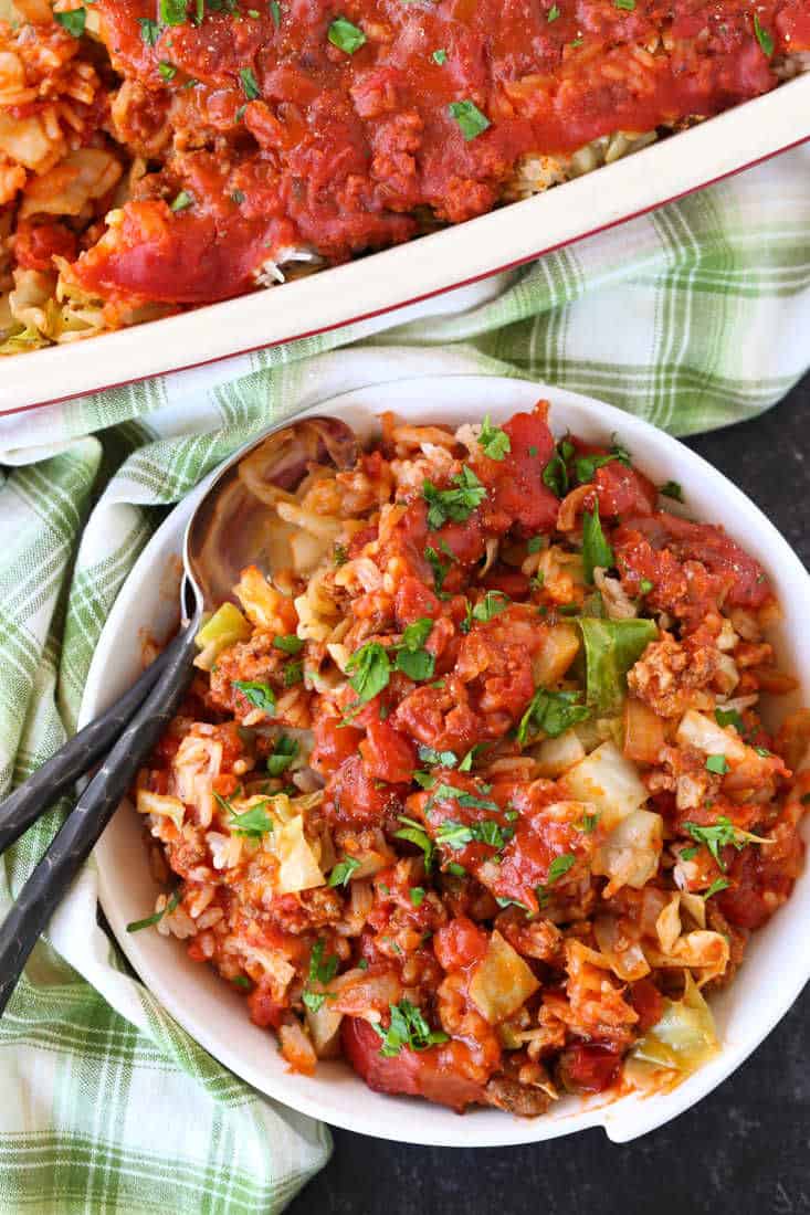 This Cabbage Roll Casserole is a comforting, easy to make dinner recipe! All your favorite cabbage roll ingredients in a delicious, easy casserole! Cabbage Roll Casserole in a bowl with spoons