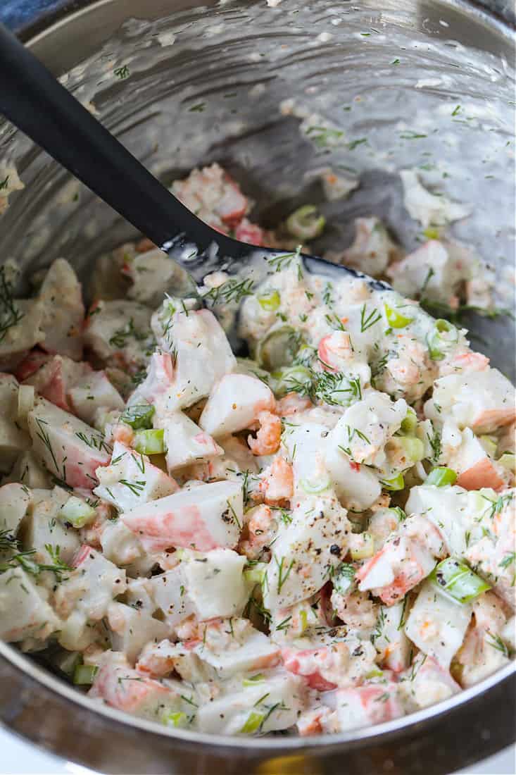 seafood salad in a bowl with spatula