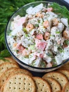 seafood salad in a glass bowl with crackers