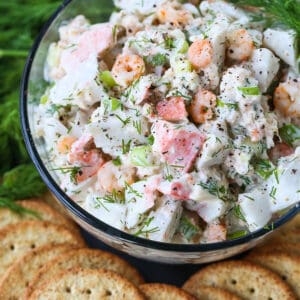 seafood salad in a glass bowl with crackers