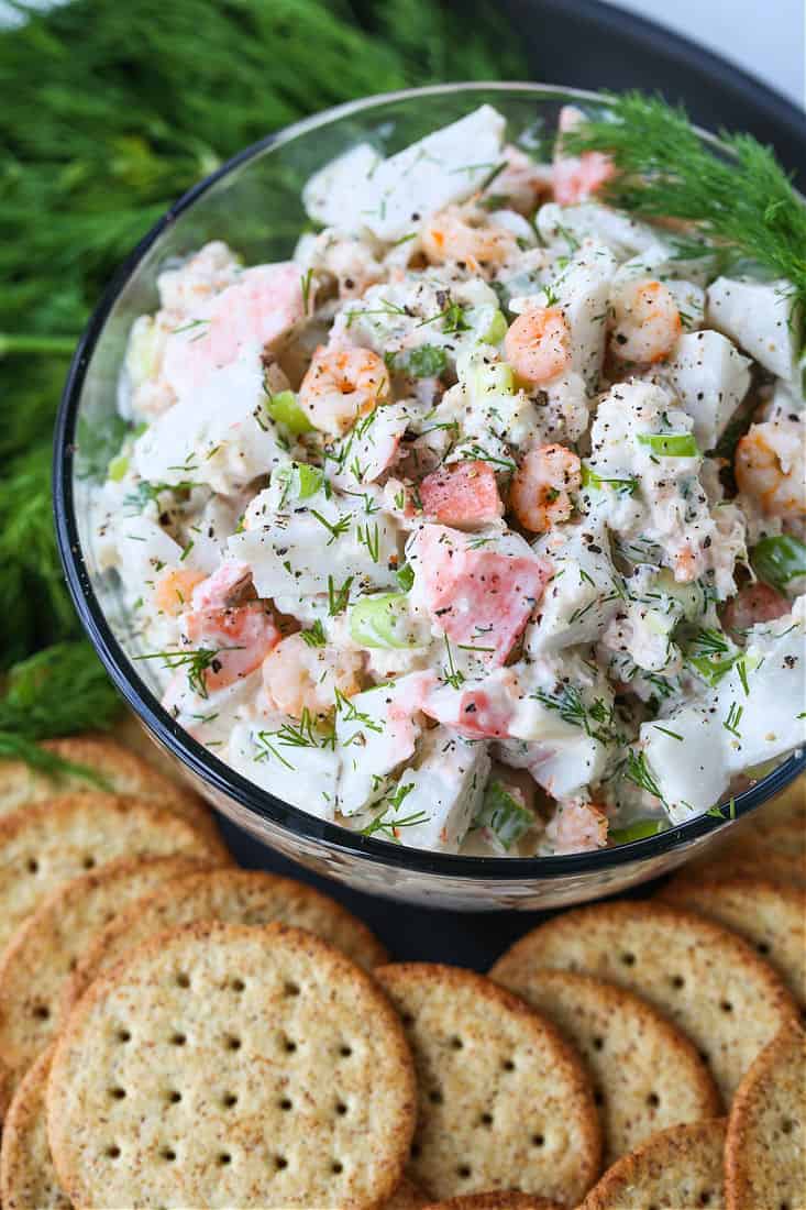 seafood salad in a glass bowl with crackers