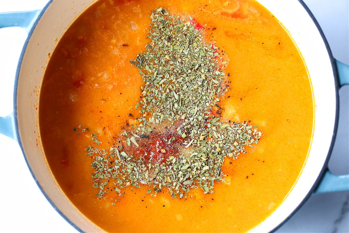 tomato soup in a pot with dried oregano