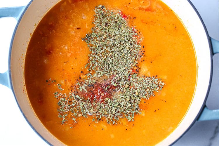Tomato soup in a pot with seasonings