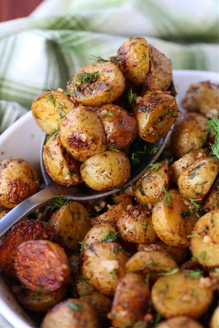 Garlic Dill Roasted Potatoes on a serving spoon
