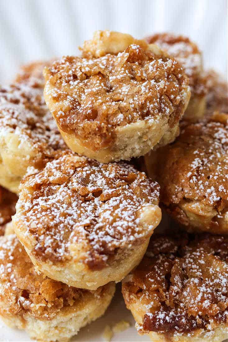 Cookies stacked on a plate with powdered sugar