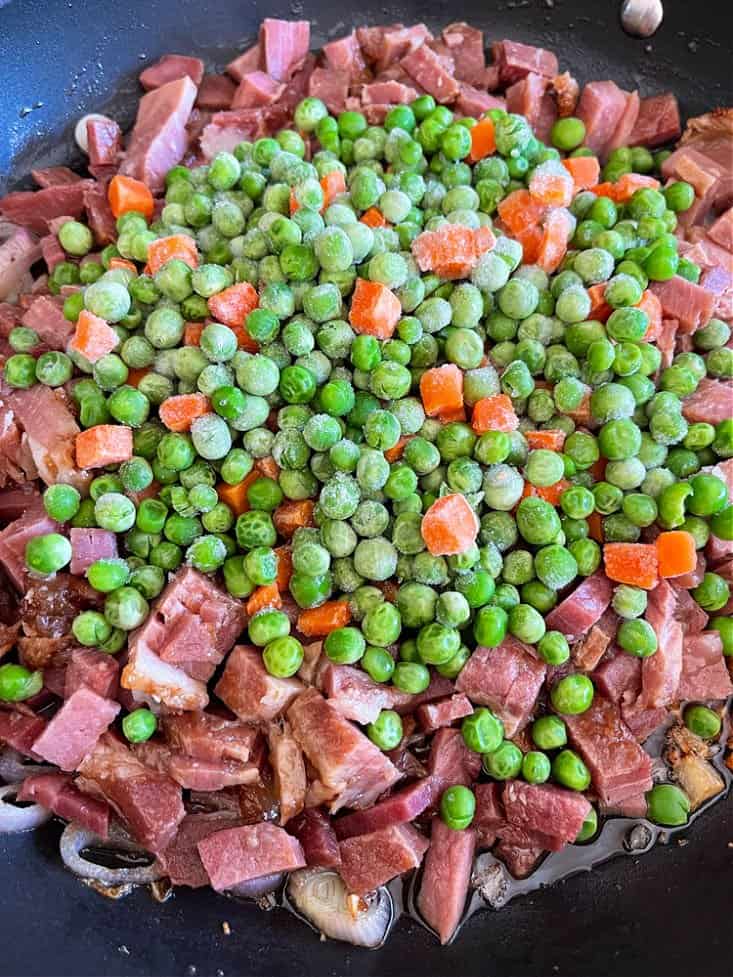 frozen vegetables and leftover ham in a skillet for making pasta recipe