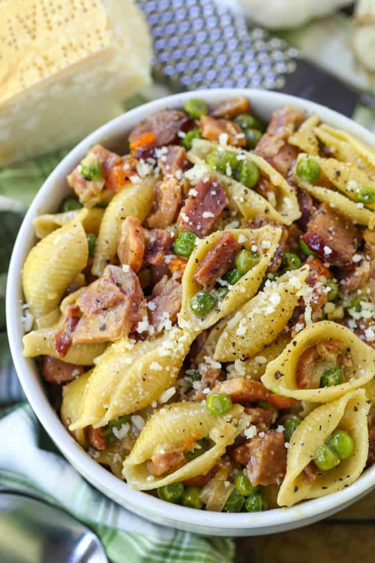 Pasta with Ham and Peas recipe in a bowl with green napkin
