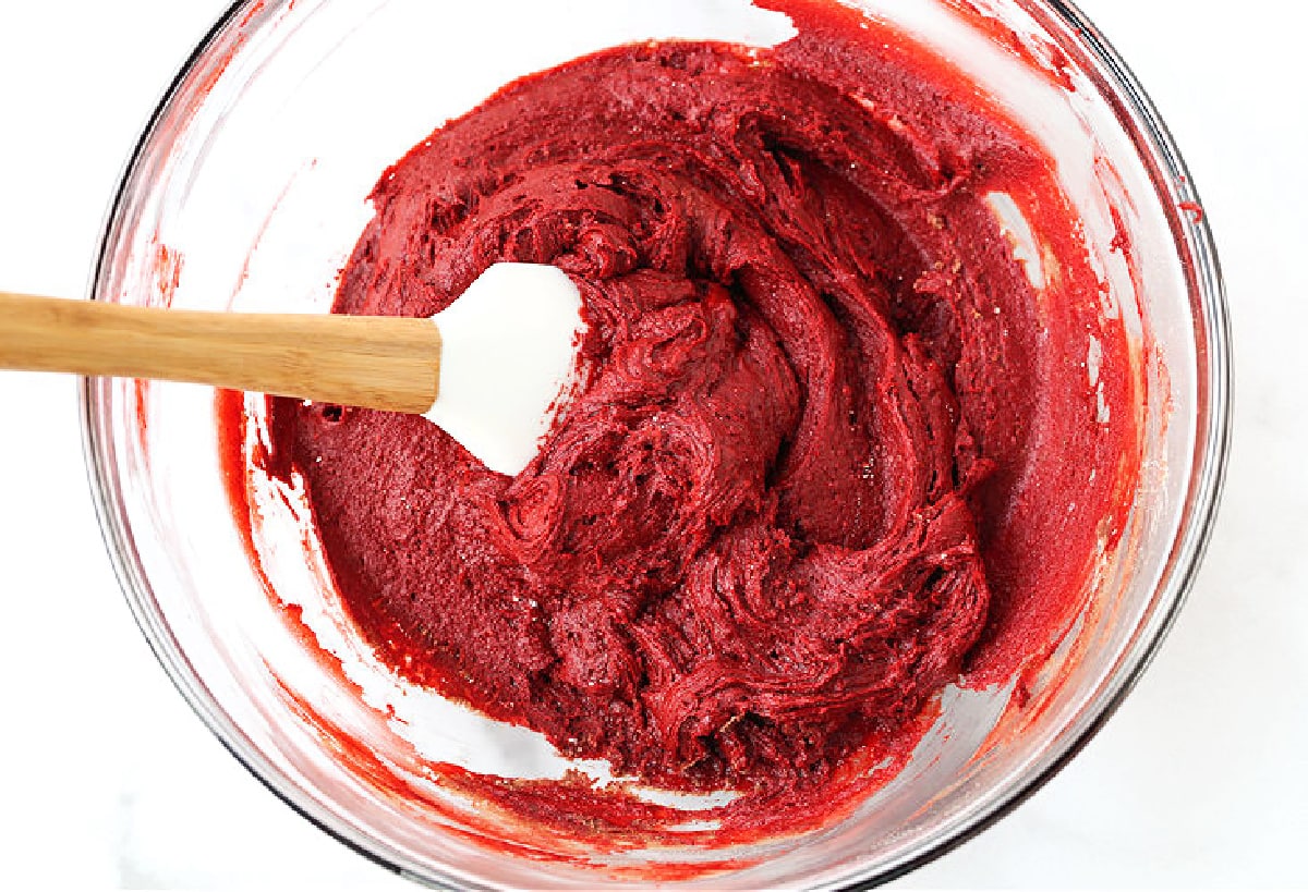 red velvet cake batter in bowl with spatula