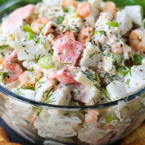 close up of seafood salad in glass bowl