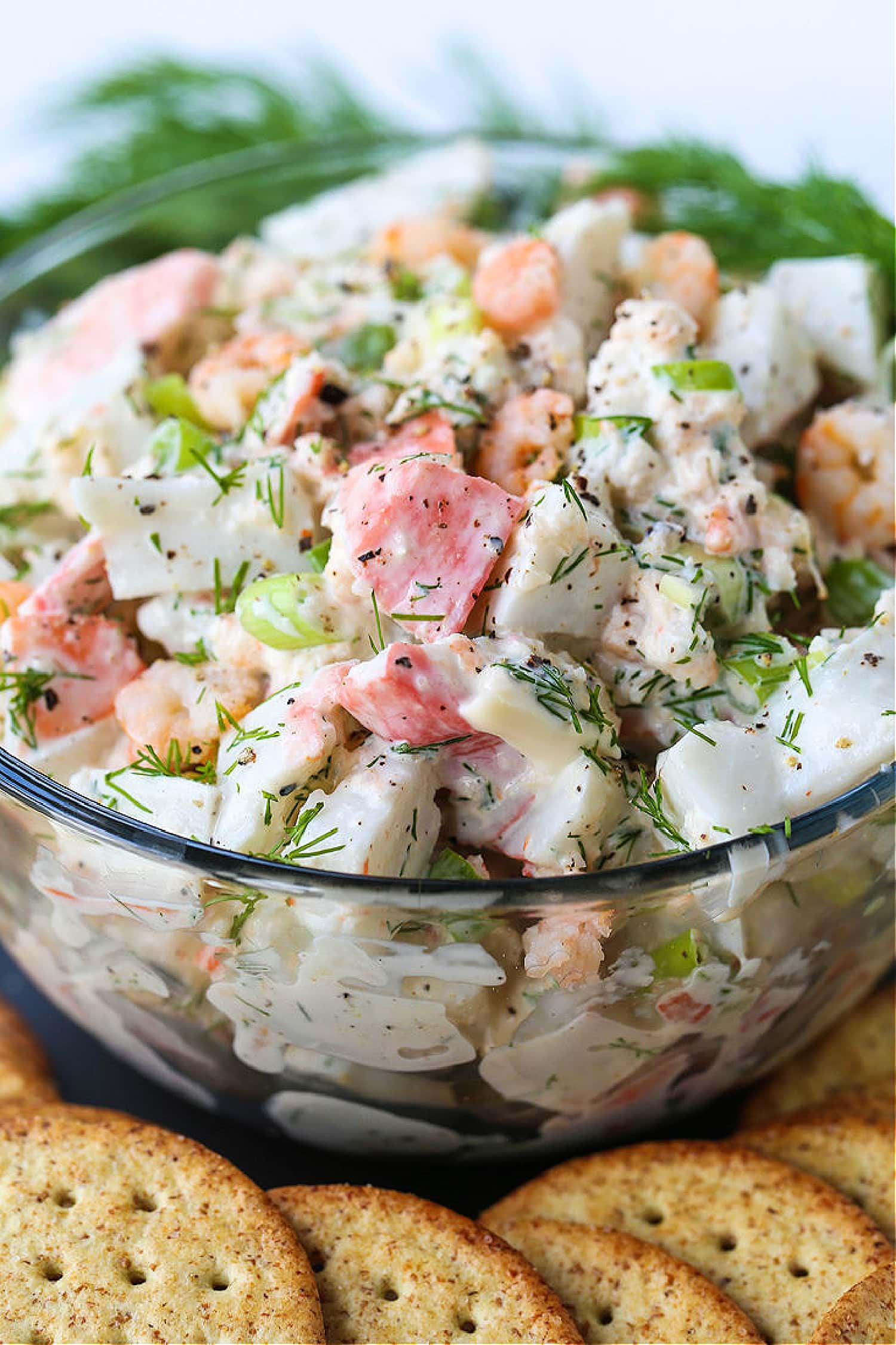 close up of seafood salad in glass bowl