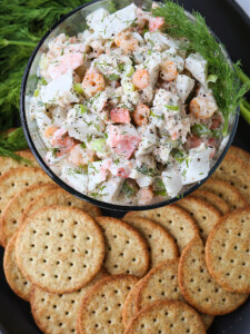 seafood salad in glass bowl with crackers