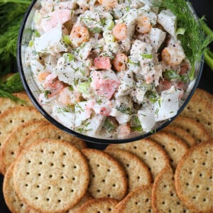 seafood salad in glass bowl with crackers