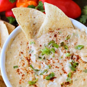 Tex-Mex Crab Dip in a white bowl with tortilla chips