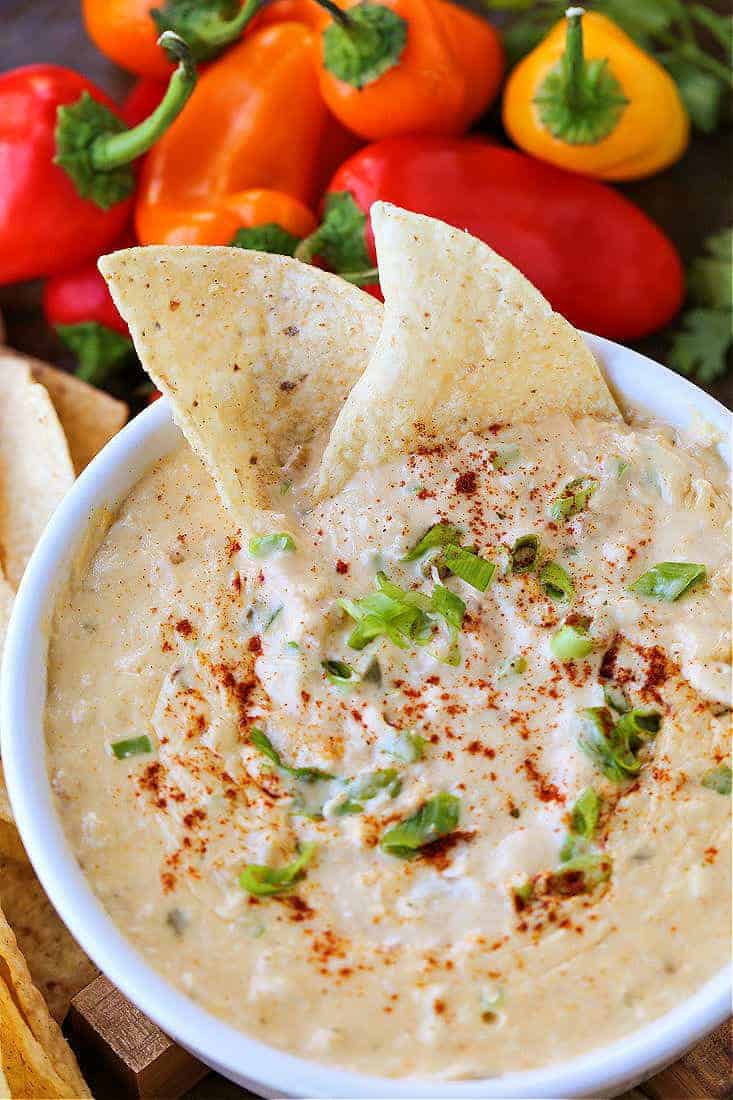 Tex-Mex Crab Dip in a white bowl with tortilla chips