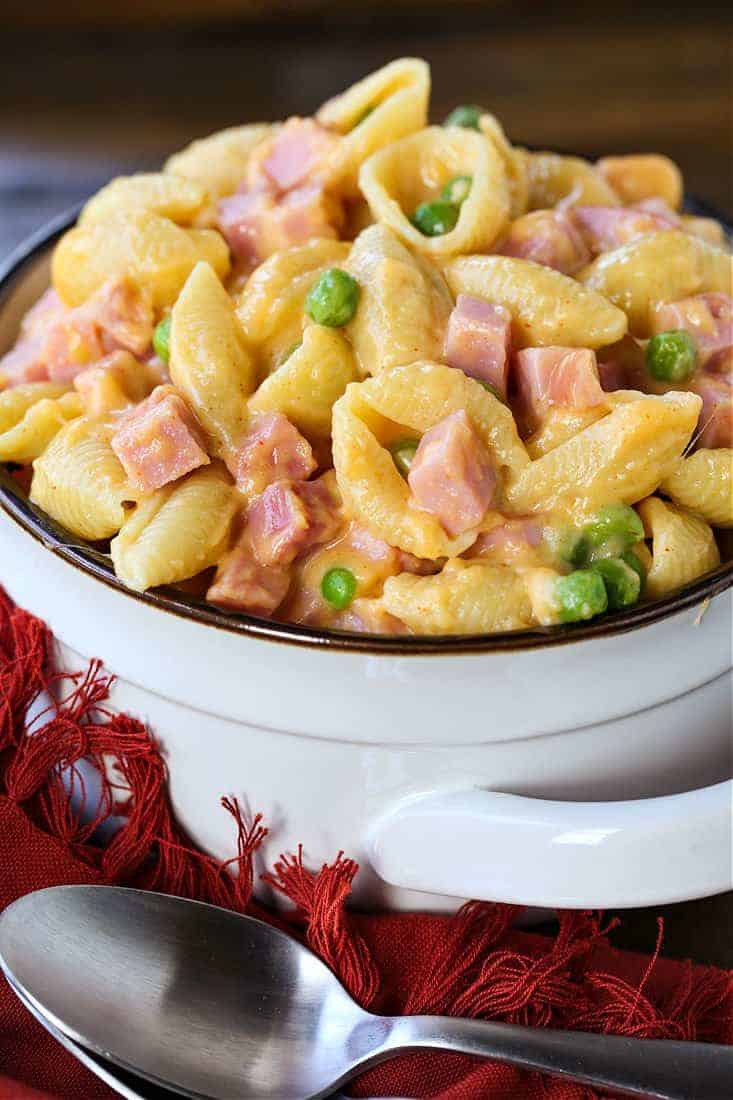 Macaroni and cheese with ham in a white bowl