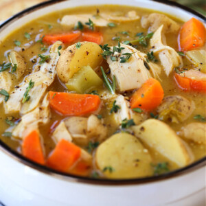 chicken stew in white crock with napkin