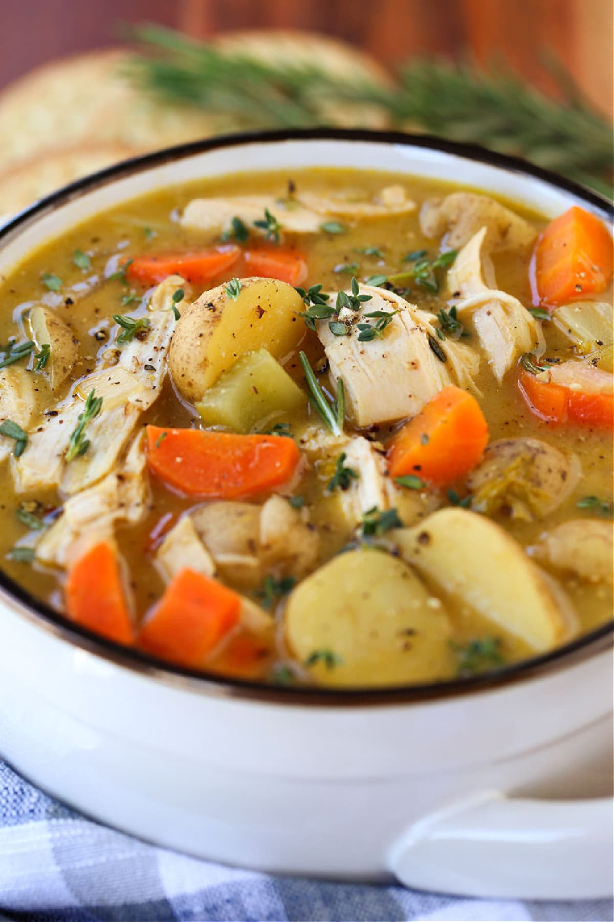 chicken stew in white crock with napkin