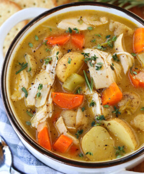 chicken stew in white bowl with spoon