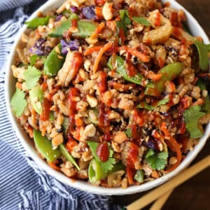 Peanut Chicken Fried Rice in a white bowl with napkin