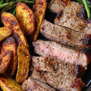 Sliced steak, potatoes and green beans on a plate