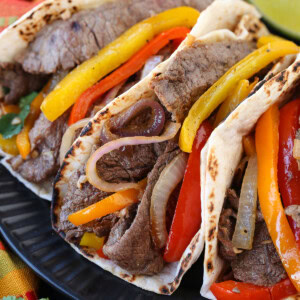 steak fajitas on black plate close up