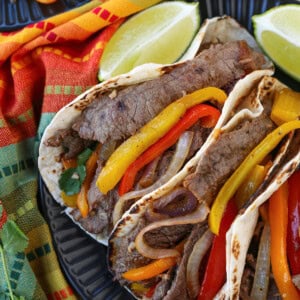 steak fajitas from the top with napkin and limes