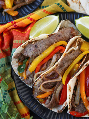steak fajitas from the top with napkin and limes