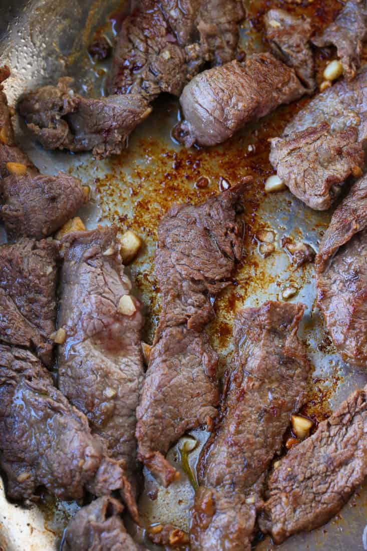 Seared flank steak in a skillet for making a fajita recipe