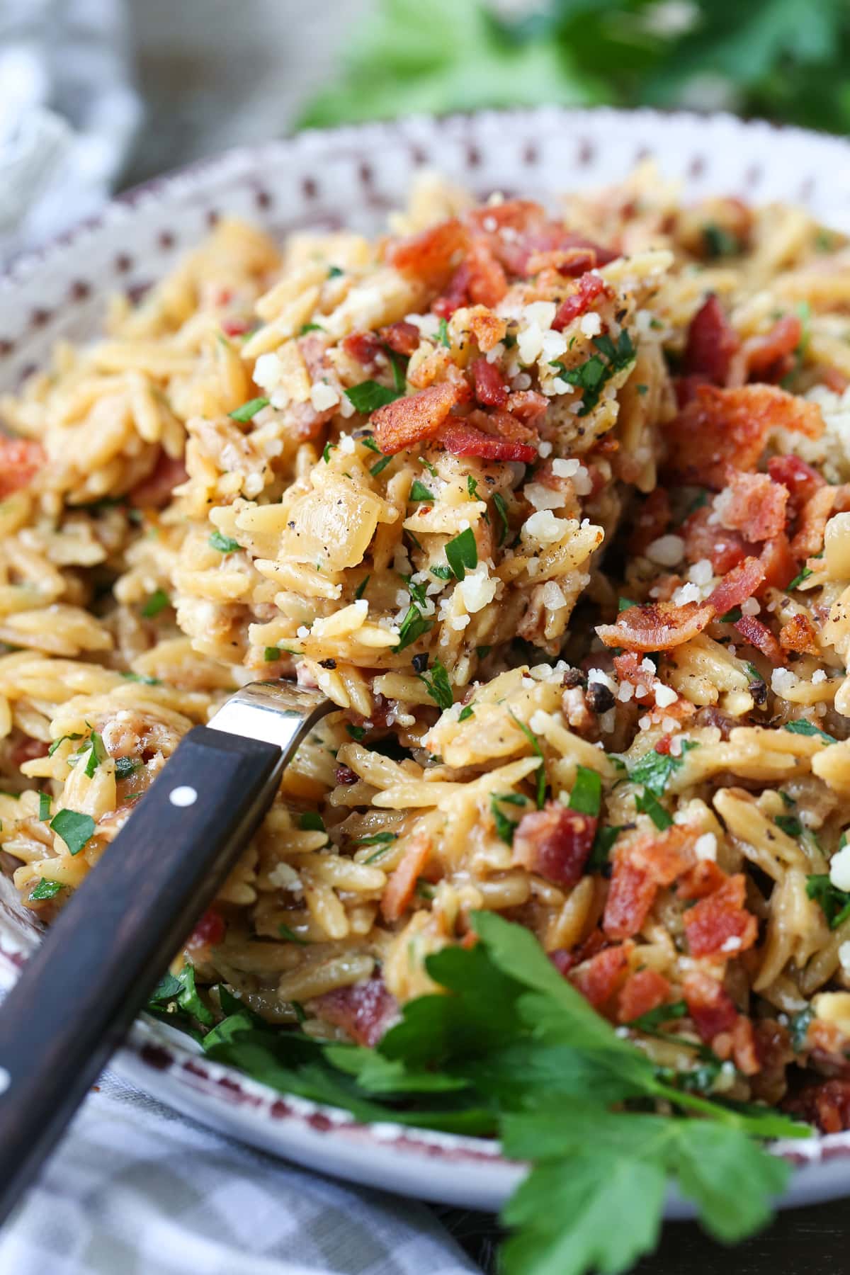 bacon and parmesan orzo on serving spoon