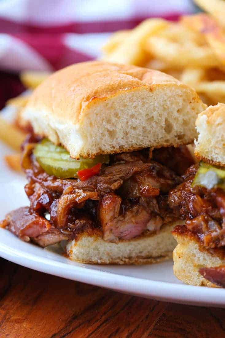 BBQ Rib Sandwich sliced in half on a plate