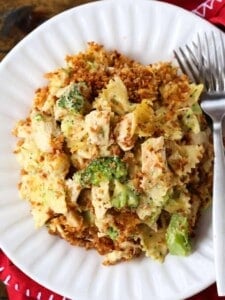 Chicken and broccoli casserole on a white platte with forks