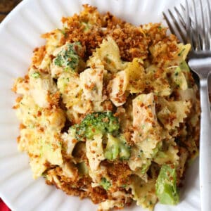 Chicken and broccoli casserole on a white platte with forks