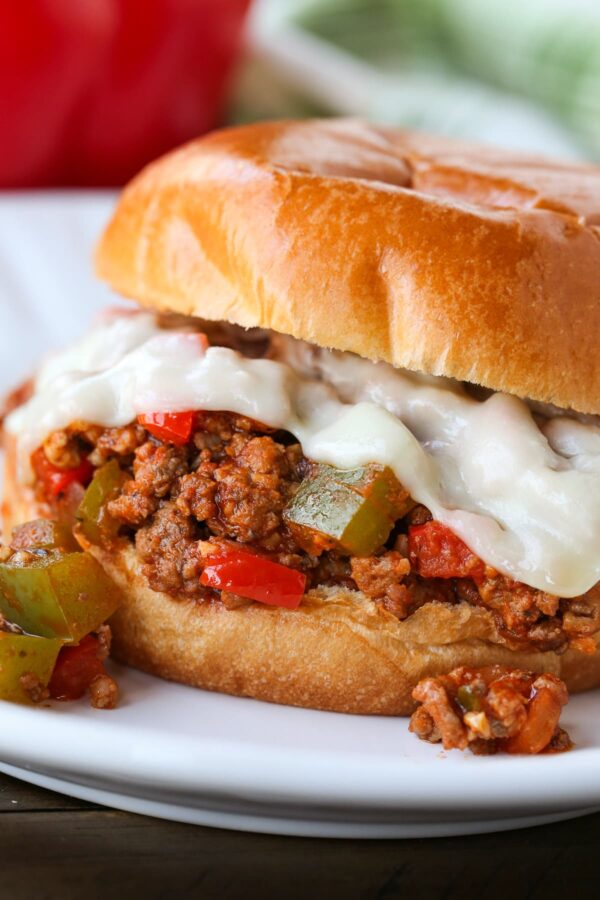 sloppy joe sandwich with melted mozzarella cheese on plate