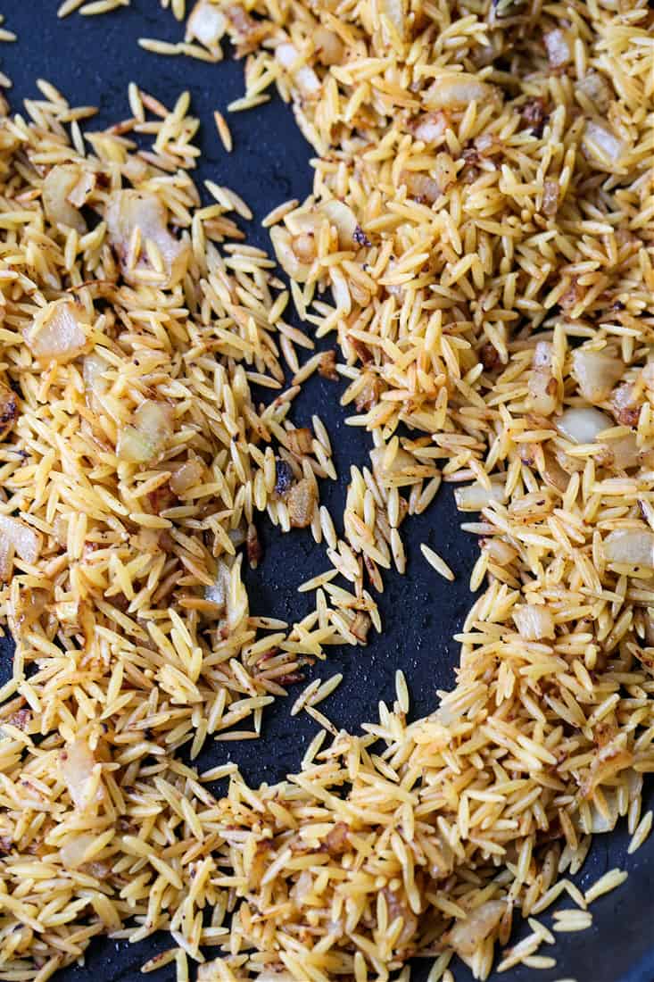 Toasted orzo in a skillet for side dish recipe