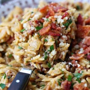 Orzo recipe with bacon and parmesan cheese on a spoon