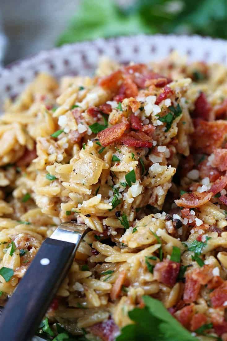 Orzo recipe with bacon and parmesan cheese on a spoon