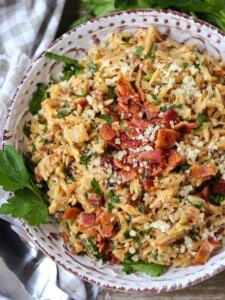 Orzo recipe with parmesan cheese and bacon in a bowl