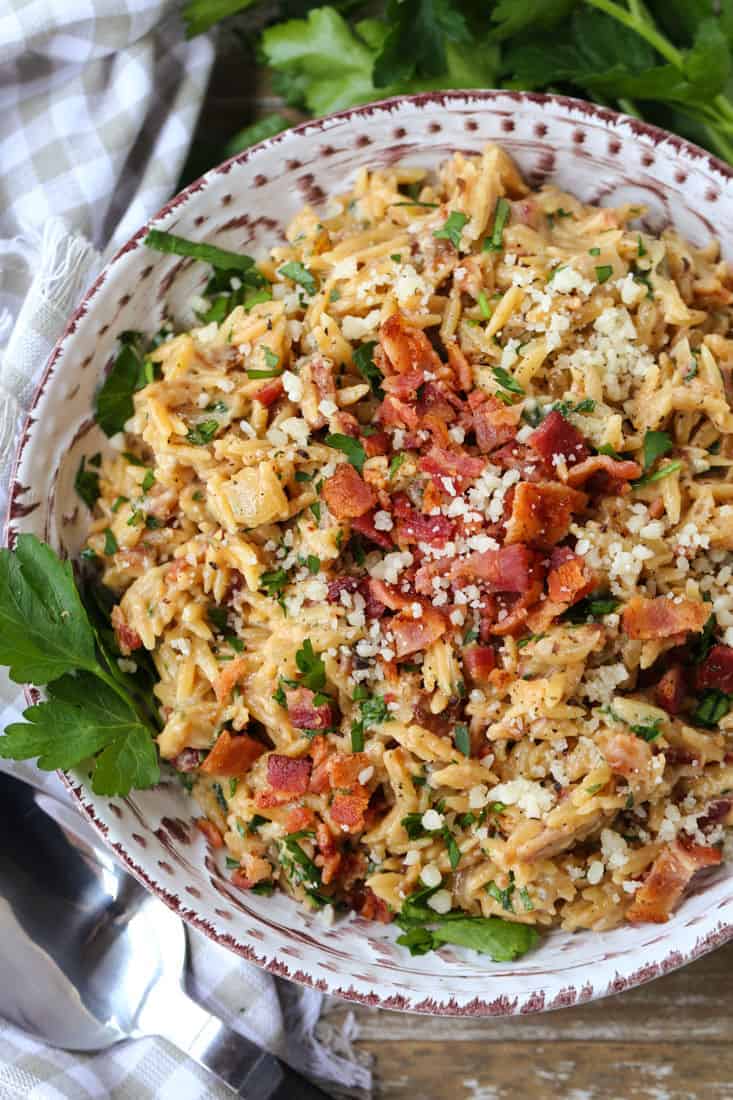 Orzo recipe with parmesan cheese and bacon in a bowl