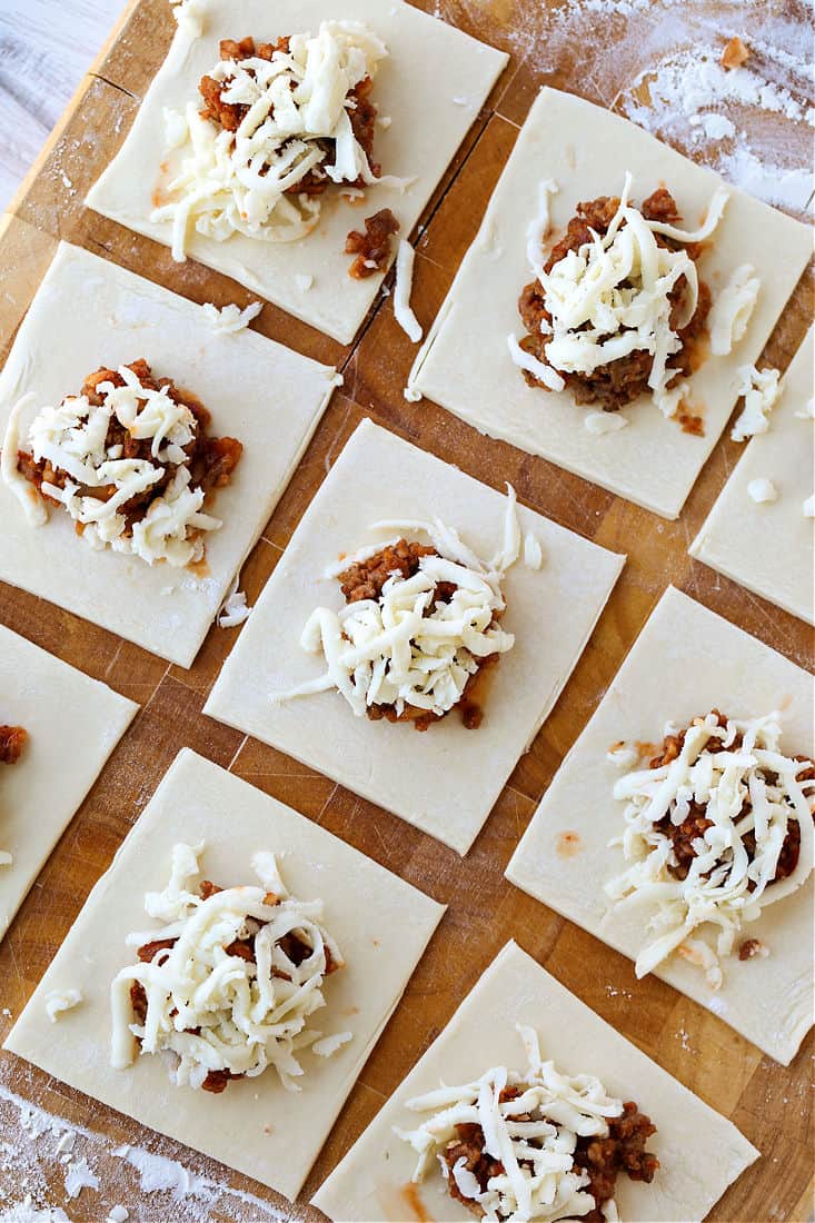 Sausage and cheese filling on puff pastry squares