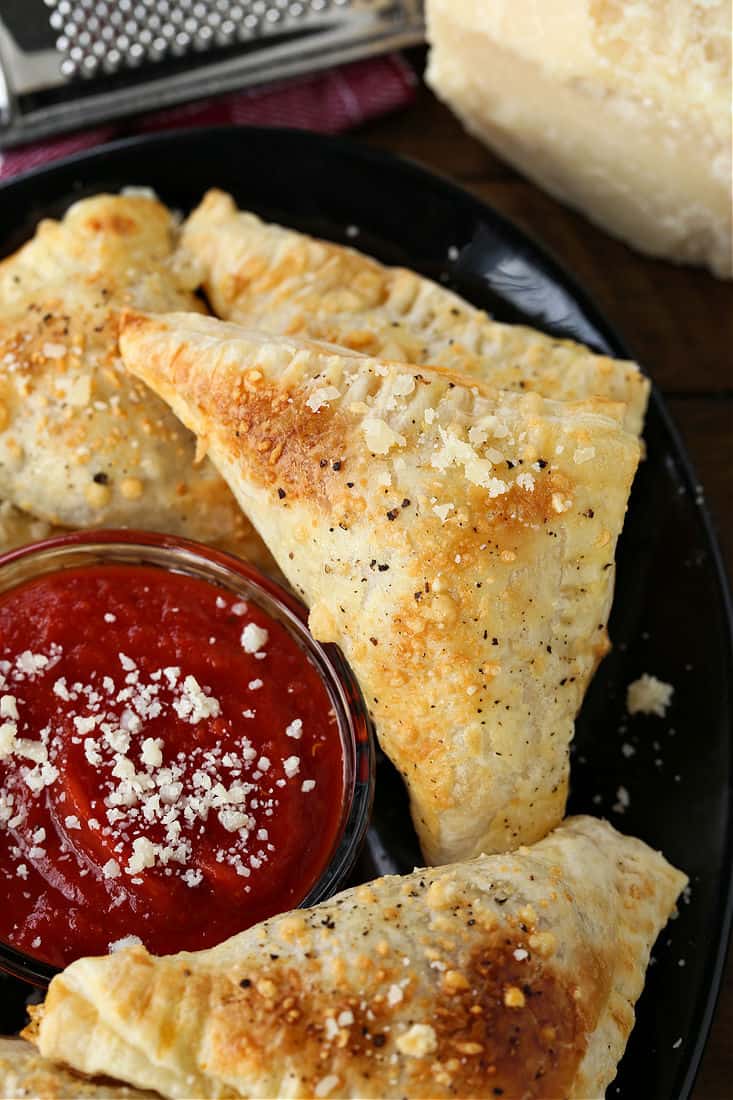 Puff pastry pizza pockets filled with sausage, mushrooms and cheese
