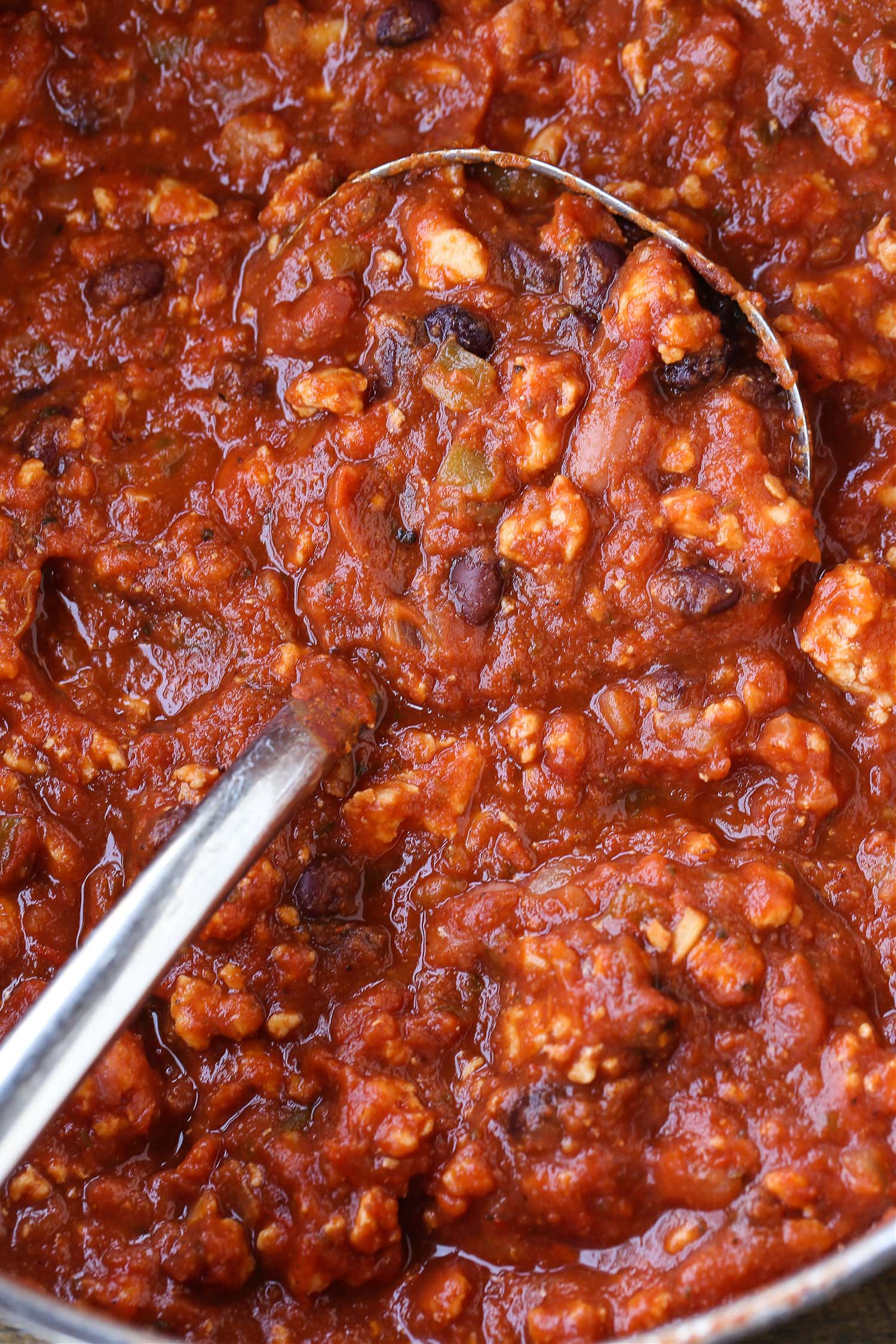 chicken chili in a pot with a ladle